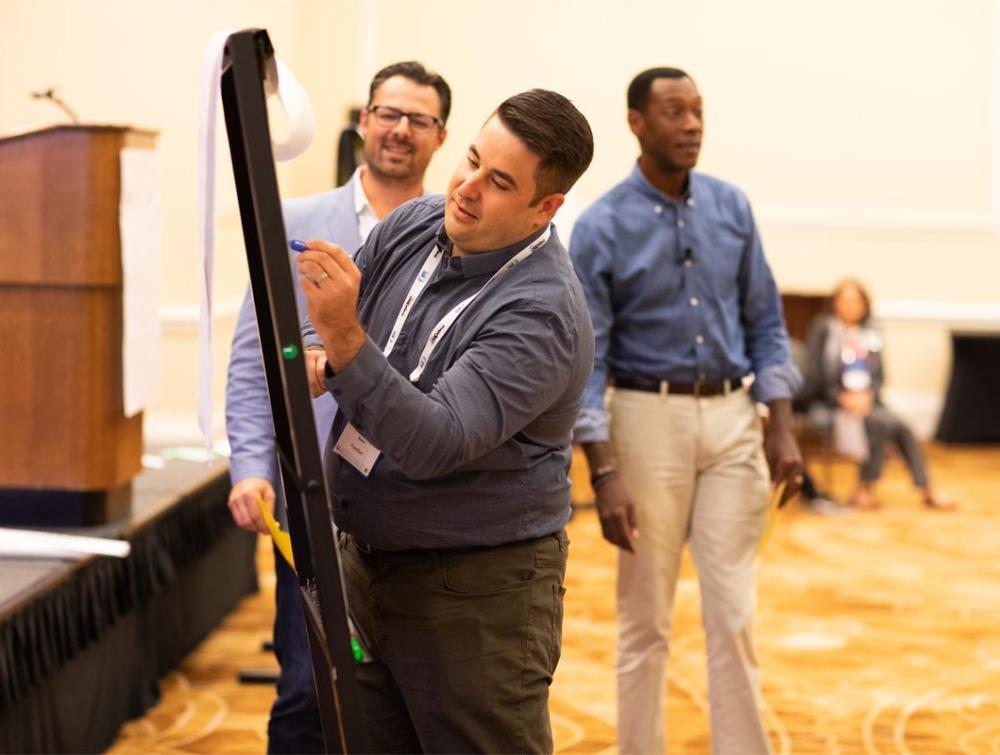 Franchise consultant training session with participants brainstorming.